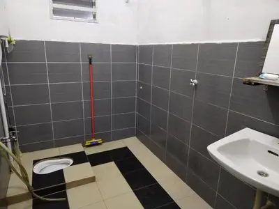 a bathroom with a toilet and a sink at Seadanya Homestay Kamunting in Kampong Melayu Changkat Larah