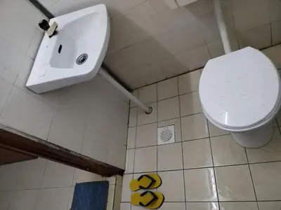a bathroom with a toilet and a sink at Seadanya Homestay Kamunting in Kampong Melayu Changkat Larah