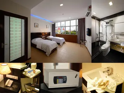 a hotel room with a bed and a bathroom at ERNES Hotel Bandar Perda in Kampong Permatang Batu