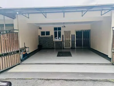 an empty garage with a gate and a building at Seri Changkat Homestay in Kampong Changkat Raja