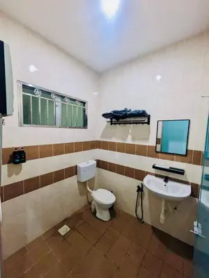 a bathroom with a toilet and a sink at Seri Changkat Homestay in Kampong Changkat Raja
