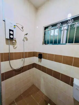 a bathroom with a shower and a toilet at Seri Changkat Homestay in Kampong Changkat Raja