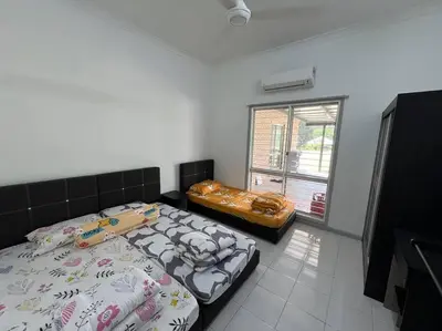 a bedroom with two beds and a window at Orchard Lake House - Entire bungalow, 4 rooms, 9 beds, 13 persons in Behrang Hulu