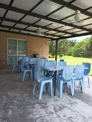 a group of blue tables and chairs under a pavilion at Orchard Lake House - Entire bungalow, 4 rooms, 9 beds, 13 persons in Behrang Hulu