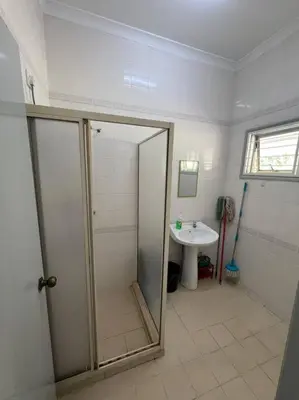a bathroom with a shower and a sink at Orchard Lake House - Entire bungalow, 4 rooms, 9 beds, 13 persons in Behrang Hulu