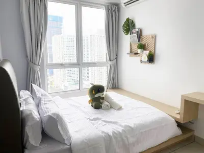 a teddy bear sitting on a bed in a bedroom at Cozy 1Bedroom- 26th- Gurney - Mansion One in George Town
