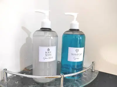 two bottles of soap are sitting on a shelf at Cozy 1Bedroom- 26th- Gurney - Mansion One in George Town