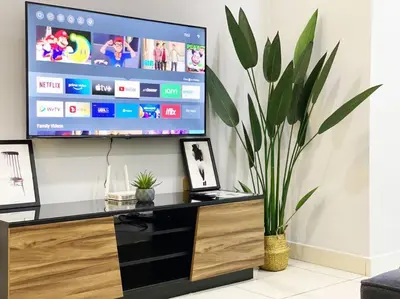 a living room with a large tv on a wall at Cozy 1Bedroom- 26th- Gurney - Mansion One in George Town