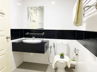 a white bathroom with a toilet and a sink at Cozy 1Bedroom- 26th- Gurney - Mansion One in George Town