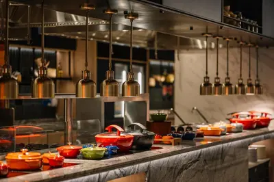 a kitchen with many pots and pans on a counter at Iconic Regency Service Residences, managed by Iconic Hotel in Bayan Lepas