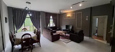 a living room with a table and chairs and a couch at Big Mama's House in Tanah Rata