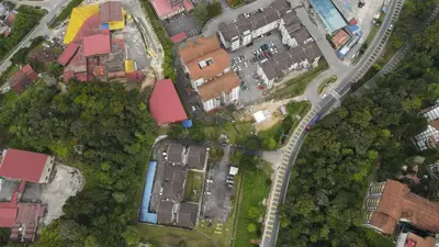 an overhead view of a city with houses and a road at Big Mama's House in Tanah Rata