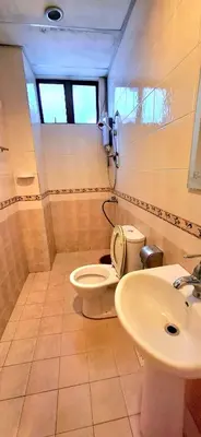 a bathroom with a toilet and a sink at Big Mama's House in Tanah Rata