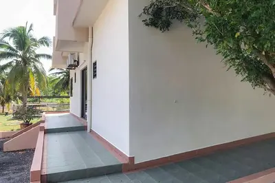 a corridor of a house with a white wall at Lumut Villa Inn in Kampong Tebing Rabak