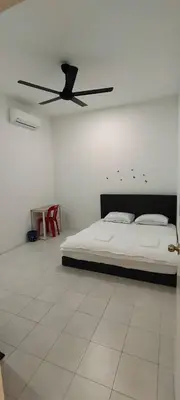 a bedroom with a bed and a ceiling fan at Homestay Bandar Puteri Jaya in Sungai Petani