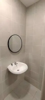 a bathroom with a sink and a mirror on the wall at Homestay Bandar Puteri Jaya in Sungai Petani