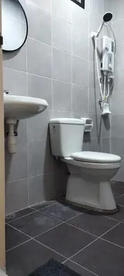 a bathroom with a toilet and a sink at Homestay Bandar Puteri Jaya in Sungai Petani