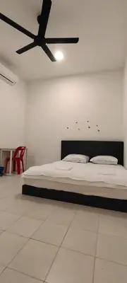 a bedroom with a bed and a ceiling fan at Homestay Bandar Puteri Jaya in Sungai Petani