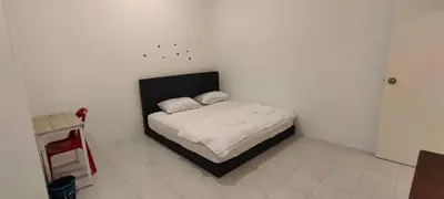 a bedroom with a bed in a white room at Homestay Bandar Puteri Jaya in Sungai Petani