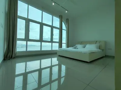a white room with a couch and a large window at Seaview Vacation Condo 3R3B 8Pax in Kampong Batu Maung