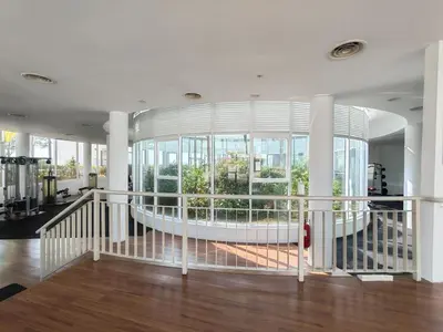 a large room with a large window and a gym at Seaview Vacation Condo 3R3B 8Pax in Kampong Batu Maung