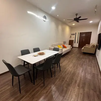 a living room with a table and chairs and a couch at Cozy Corner Home Alma Near AEON \u5927\u5c71\u811a\u6e29\u99a8\u6c11\u5bbf in Bukit Mertajam
