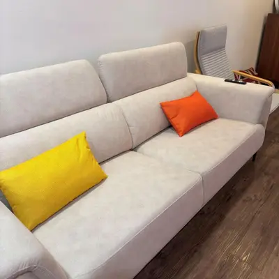 a white couch with two colorful pillows on it at Cozy Corner Home Alma Near AEON \u5927\u5c71\u811a\u6e29\u99a8\u6c11\u5bbf in Bukit Mertajam