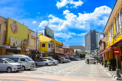 a city street with cars parked on the street at De Quinton Hotel in Ipoh