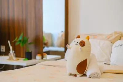 a toy bear sitting on top of a bed at Mansion One l 4pax Studio l MountainView & CityView l Gleneagles l by PerfectSweetHome in George Town
