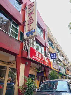 a hotel sign on the side of a building at Hotel Kavanass Inn in Simpang