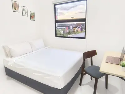 a bedroom with a bed and a desk and a laptop at IFS Seri Iskandar by Glex in Seri Iskandar