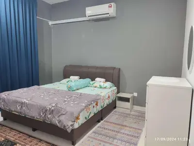 a bedroom with a bed with a projector on the wall at Harmoni Citra Guesthouse Bertam in Kampong Sungai Korok