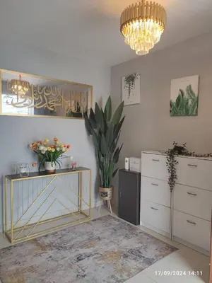 a living room with a dresser and a chandelier at Harmoni Citra Guesthouse Bertam in Kampong Sungai Korok