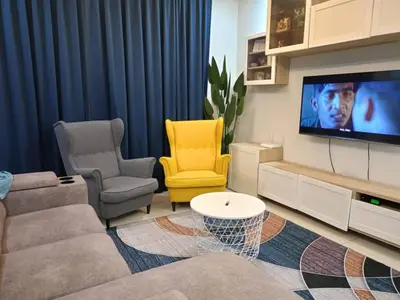 a living room with a couch and a tv at Harmoni Citra Guesthouse Bertam in Kampong Sungai Korok