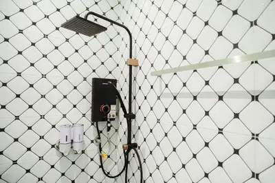 a shower with a hose attached to a wall at Jovial Industrial Stylish Lodge ````Bukit Mertajam in Bukit Mertajam