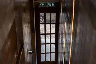 a door with a sign on it in a building at Jovial Industrial Stylish Lodge ````Bukit Mertajam in Bukit Mertajam