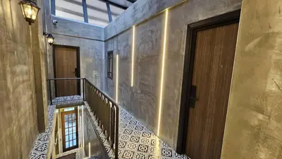 a staircase in a building with two doors and a hallway at Jovial Industrial Stylish Lodge ````Bukit Mertajam in Bukit Mertajam
