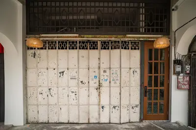 an entrance to a building with a wooden door at Jovial Industrial Stylish Lodge ````Bukit Mertajam in Bukit Mertajam
