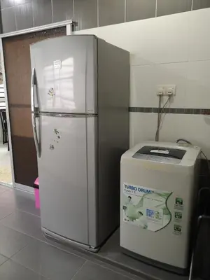 a refrigerator and a trash can in a room at \u4f18\u96c5\u805a\u6c11\u5bbf in Kampong Kuala Punti