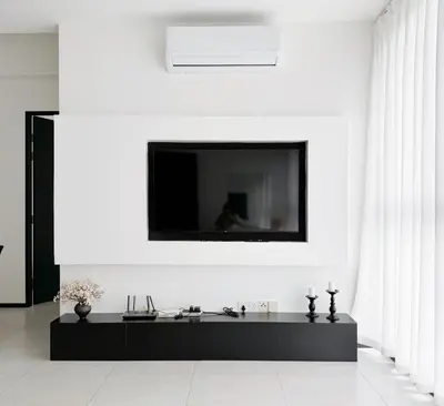 a living room with a tv on a white wall at Georgetown Childroom Seaview & Cityview Infinity Pool with 2 Carpark in Jelutong