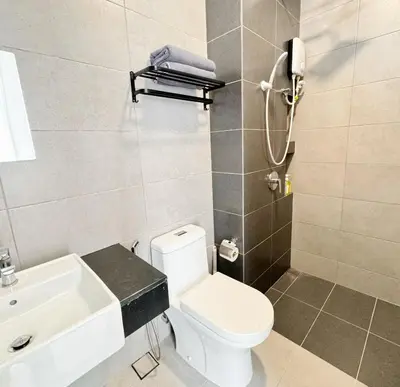 a bathroom with a white toilet and a sink at Georgetown Childroom Seaview & Cityview Infinity Pool with 2 Carpark in Jelutong