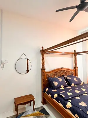 a bedroom with a bed and a ceiling fan at Homestay Ummi Seri Iskandar in Seri Iskandar