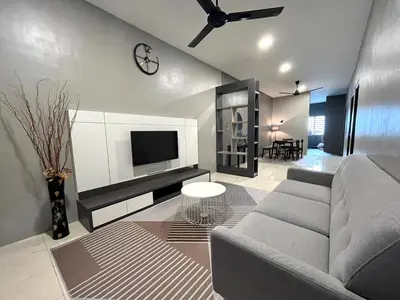 a living room with a couch and a tv at AbelHome in Teluk Intan
