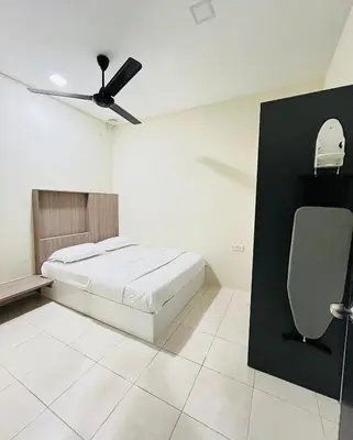 a bedroom with a bed and a ceiling fan at AbelHome in Teluk Intan