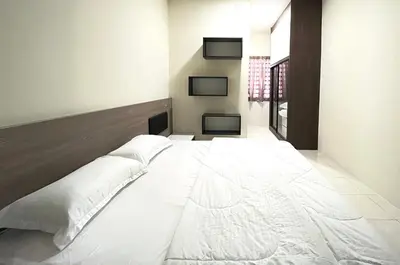 a large white bed in a room at AbelHome in Teluk Intan