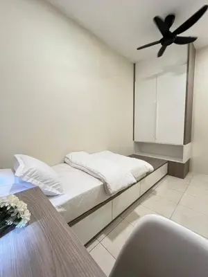 a bedroom with a bed with a ceiling fan at AbelHome in Teluk Intan