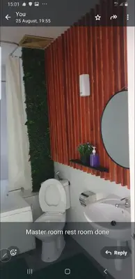a bathroom with a toilet and a sink and a mirror at Crystal Creek Taiping in Taiping