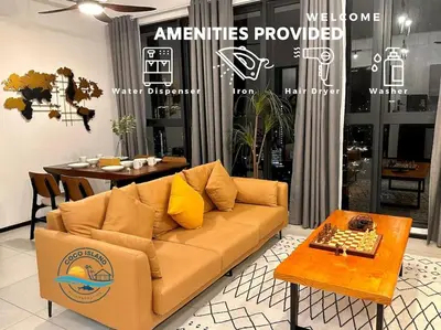 a living room with a couch and a table at Urban Seaview with Infinity Pool, Luxury Modern Stylish 7pax 3Bedroom 3Queen in Jelutong