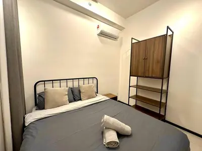 a bedroom with a bed with a hat on it at Urban Seaview with Infinity Pool, Luxury Modern Stylish 7pax 3Bedroom 3Queen in Jelutong