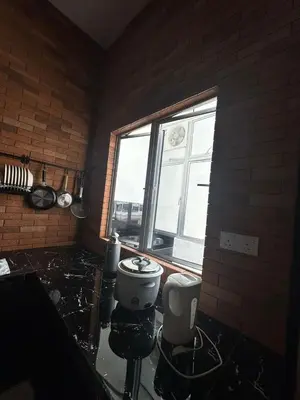 a bathroom with a toilet and a window at Adik aisyah Cameron Black Pink in Tanah Rata